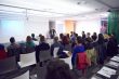 speaker on education conference presentation at modern startup interior